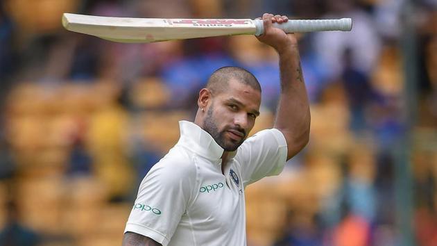 India's Shikhar Dhawan acknowledges the applause of the crowd as he walks back to the pavillion after losing his wicket on the first day of the one-off cricket test match against Afghanistan.(PTI)