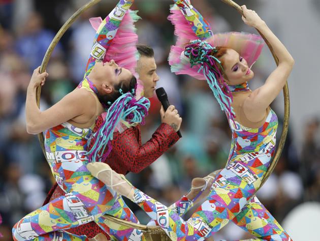 Acrobats perform along side Williams. (AP) Acrobats perform along side Williams. (AP)