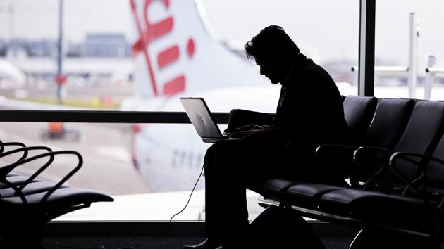 A passenger uses a laptop at Sydney Airport. (Bloomberg)