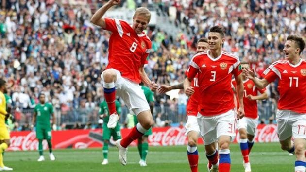 Russia's Yury Gazinsky celebrates scoring their first goal with team mates. (REUTERS)