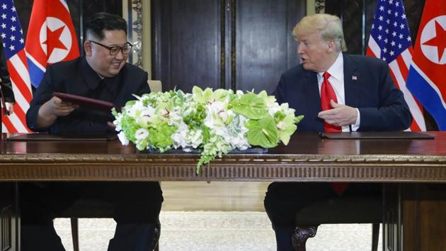 North Korea leader Kim Jong Un and US President Donald Trump exchanged signed documents at the Capella resort on Sentosa Island in Singapore on June 12. (AP Photo) North Korea leader Kim Jong Un and US President Donald Trump exchanged signed documents at the Capella resort on Sentosa Island in Singapore on June 12. (AP Photo)