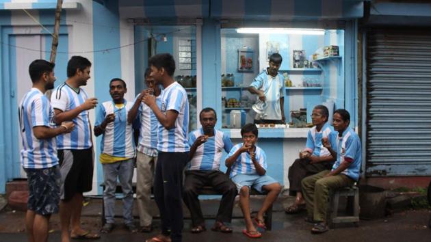 Fans of the Argentinian football team drink tea in front of a three-storey apartment painted in the team’s blue-and-white ahead of the 2018 World Cup in Kolkata, West Bengal on June 11, 2018. (AFP)