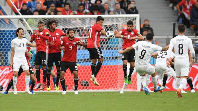 Uruguay's forward Luis Suarez (2R) fires a free kick into the defensive wall. (AFP)