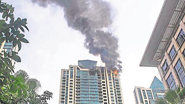 A fire, which broke out at a Mumbai highrise on Wednesday, charred the top three floors.(Pratik Chorge/HT Photo)