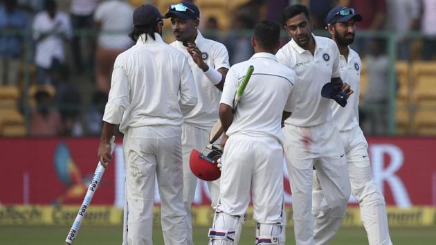 Members of Indian cricket team greet each other and Afghanistan's Hashmatullah Shahidi (3R) after India won the one-off cricket test match in Bangalore, India, Friday, June 15, 2018.(AP)