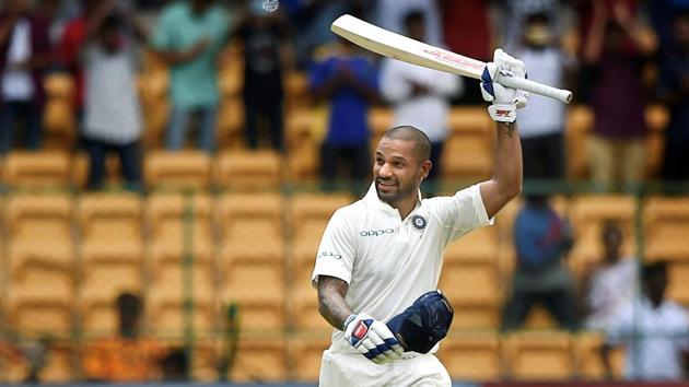 Shikhar Dhawan celebrates his century on the first day of the one-off cricket test match against Afghanistan, at Chinnaswamy Stadium in Bengaluru on June 14, 2018. (Shailendra Bhojak / PTI)