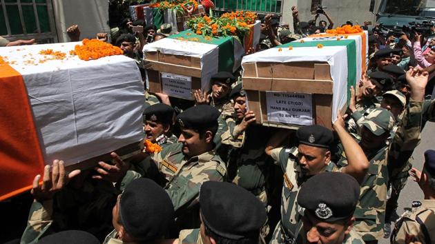 Border Security Force (BSF) officers carry the coffin of slain soldiers during a wreath-laying ceremony at the BSF headquarters in Jammu on June 13, 2018. (AFP)