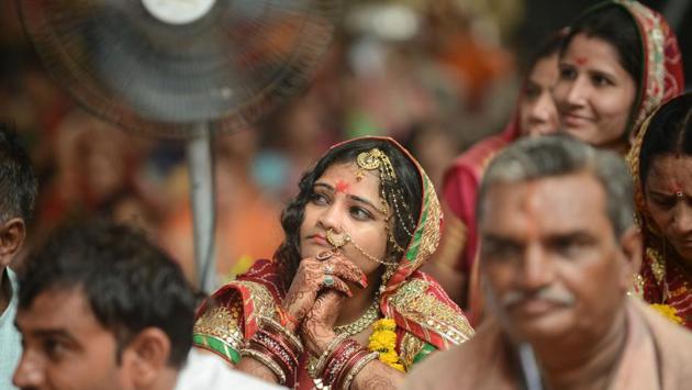 A woman from Rajasthan’s Nagar community (C) looks on during ‘Gangathali’ ceremony in the outskirts of Ahmedabad, Gujarat on June 10, 2018. (Sam Panthaky / AFP)