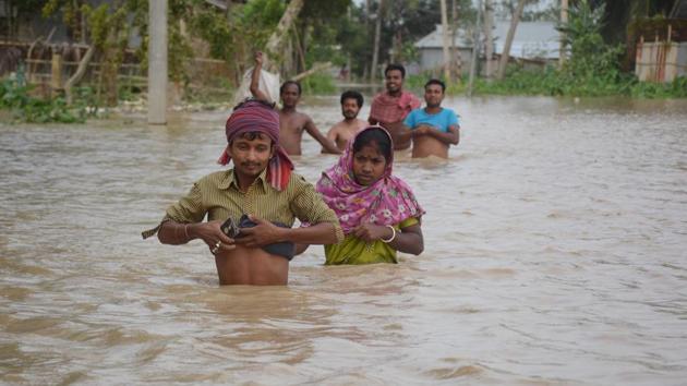 Villagers wade through a flooded street after heavy downpour in Baldakhal village, on the outskirts of Agartala, Tripura. (AFP) Villagers wade through a flooded street after heavy downpour in Baldakhal village, on the outskirts of Agartala, Tripura. (AFP)