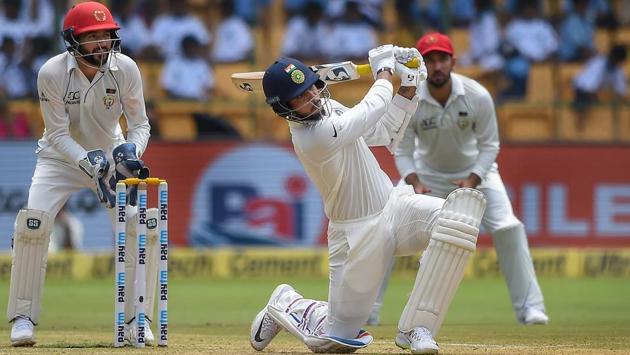 Umesh Yadav plays a shot during the second day of the one-off test match against Afghanistan at M Chinnaswamy Stadium, in Bengaluru. (Shailendra Bhojak / PTI)