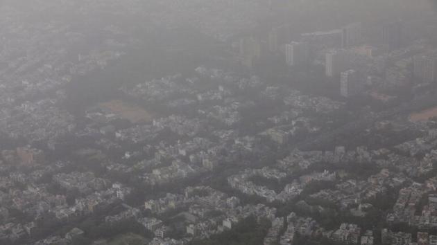 Buildings are seen blanketed by haze and dust on the outskirts of New Delhi.(Reuters)