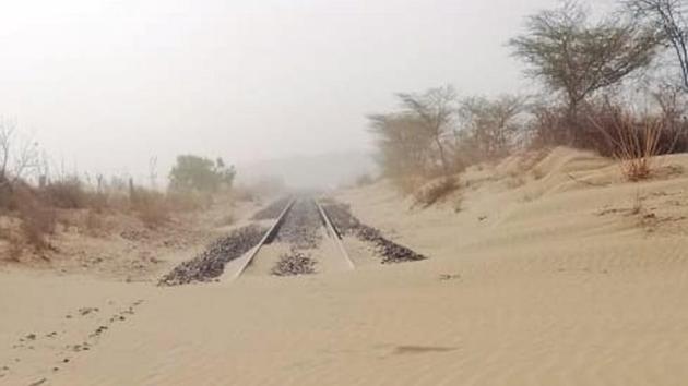 Dust storm covers a railway track in the border areas of Barmer.(HT Photo)