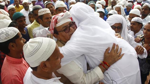People greet each other after the morning prayers at an Eidgah in Gurugram. (Yogendra Kumar / HT Photo)