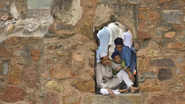 People rest after completion of the morning prayers at the Feroz Shah Kotla Masjid in New Delhi. (Anushree Fadnavis / HT Photo)