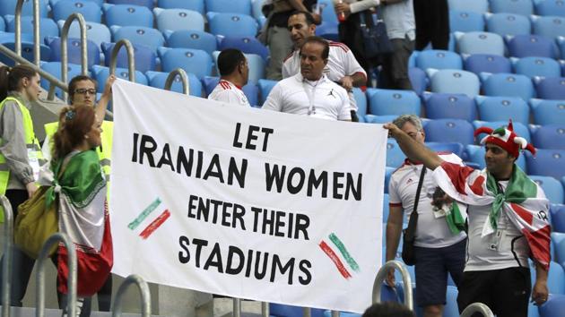 People supporting Iranian women are holding a banner at the stands during the group B match between Morocco and Iran. (AP)