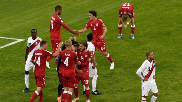 Denmark players celebrate as Peru players react after the final whistle of the Russia 2018 World Cup in a closely-fought encounter which they won 1-0. (AFP)
