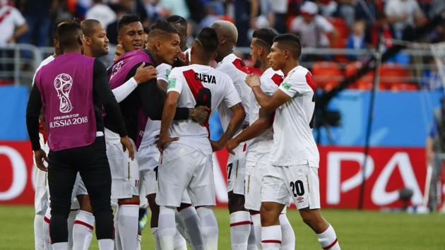 Peru's midfielder Christian Cueva (C) reacts as he is consoled by his teammates after failing his penalty kick. (AFP)