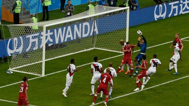 Peru's goalkeeper Pedro Gallese punches the ball as he is fouled during the encounter. (AFP)