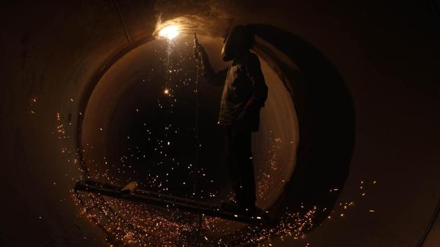 WHEN SPARKS FLY: A man protects himself from the sparks using a welding helmet and gloves, but balances himself precariously on a ladder as he welds a water pipe at Sarasbaug on Monday. (Rahul Raut/HT PHOTO) WHEN SPARKS FLY: A man protects himself from the sparks using a welding helmet and gloves, but balances himself precariously on a ladder as he welds a water pipe at Sarasbaug on Monday. (Rahul Raut/HT PHOTO)