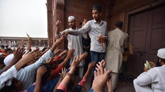 People raise their hands seeking food items before breaking their day's fast at Delhi’s Jama Masjid. As fasting during Ramadan is one of the five pillars of Islam, it is also intended to bring the faithful closer to God and to remind them of the lives of those less fortunate. (Anushree Fadnavis / HT Photo) People raise their hands seeking food items before breaking their day's fast at Delhi’s Jama Masjid. As fasting during Ramadan is one of the five pillars of Islam, it is also intended to bring the faithful closer to God and to remind them of the lives of those less fortunate. (Anushree Fadnavis / HT Photo)