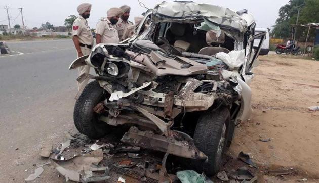 The damaged car after it collided with a parked truck on Amritsar-Jalandhar national highway 1 on Monday. (HT Photot) The damaged car after it collided with a parked truck on Amritsar-Jalandhar national highway 1 on Monday. (HT Photot)
