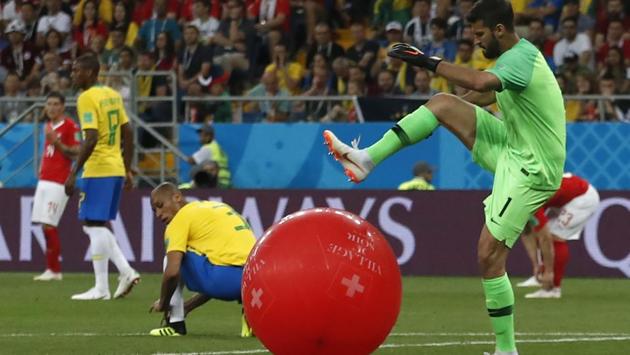 Brazil goalkeeper Alisson, right, kicks a balloon during the group E match in the Rostov Arena. (AP)