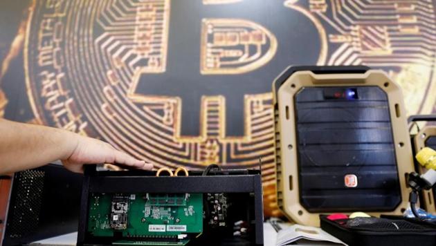 A cryptocurrency mining computer is seen in front of bitcoin logo during the annual Computex computer exhibition in Taipei, Taiwan. (REUTERS) A cryptocurrency mining computer is seen in front of bitcoin logo during the annual Computex computer exhibition in Taipei, Taiwan. (REUTERS)