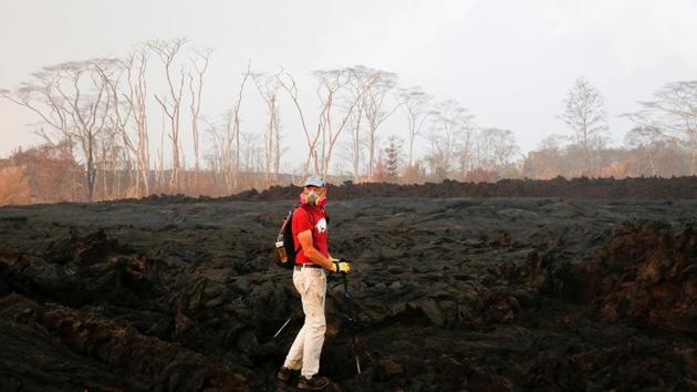 Mark Clawson, 64, attempts to walk to his home on the outskirts of Pahoa across hardened flows of lava. Clawson had evacuated when the lava flows began cutting off land access to homes. He was returning to check on his home and belongings. (Terray Sylvester / REUTERS) Mark Clawson, 64, attempts to walk to his home on the outskirts of Pahoa across hardened flows of lava. Clawson had evacuated when the lava flows began cutting off land access to homes. He was returning to check on his home and belongings. (Terray Sylvester / REUTERS)