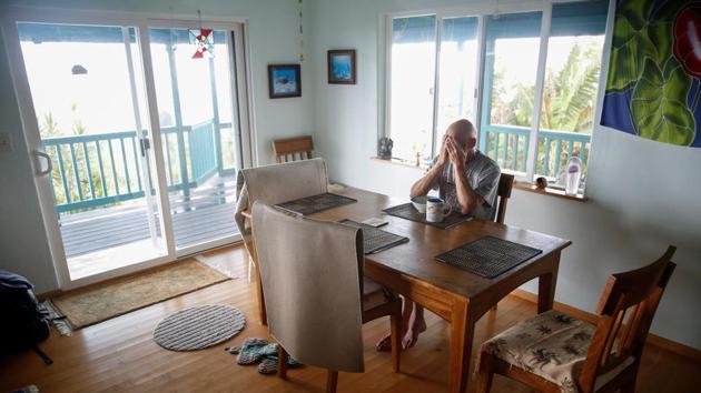 Mark Clawson, 64, rubs his eyes with exhaustion before evacuating his house on the outskirts of Pahoa, just days prior. His house is fine, but is now inaccessible. “It’s surreal. I guess I just have to convince myself that I will come back, convince myself that this is going to last,” he said, gesturing toward his house. But he already has plans to move to Oregon. (Terray Sylvester / REUTERS) Mark Clawson, 64, rubs his eyes with exhaustion before evacuating his house on the outskirts of Pahoa, just days prior. His house is fine, but is now inaccessible. “It’s surreal. I guess I just have to convince myself that I will come back, convince myself that this is going to last,” he said, gesturing toward his house. But he already has plans to move to Oregon. (Terray Sylvester / REUTERS)