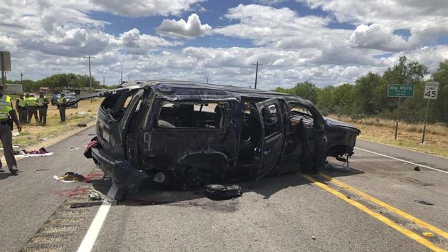 In this image tweeted by David Caltabiano of KABB/WOAI, a heavily damaged SUV is seen on Texas Highway 85 in Big Wells after crashing while carrying more than a dozen people fleeing from Border Patrol agents.(AP Photo)