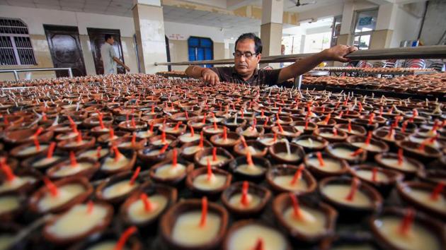 A person from the Kashmiri Pandit community arranges traditional earthen lamps at a Kheer Bhawani temple, during preparations for 'Jyeshthaashtami' annual congregation in Jammu. (PTI) A person from the Kashmiri Pandit community arranges traditional earthen lamps at a Kheer Bhawani temple, during preparations for 'Jyeshthaashtami' annual congregation in Jammu. (PTI)