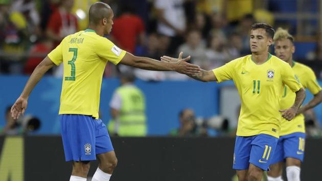 Brazil's Philippe Coutinho, right, is greeted by teammates Miranda after scoring his side's first goal against Switzerland. (AP)