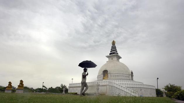 A man walking with an umbrella in a cloudy morning at replica of Shanti Stupa in New Delhi. (HT File Photo) A man walking with an umbrella in a cloudy morning at replica of Shanti Stupa in New Delhi. (HT File Photo)