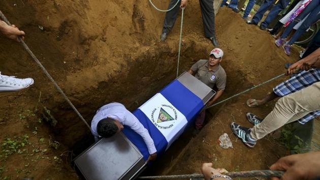 People lower the coffin of Manuel de Jesus Chavez, 38, at the cemetery in Leon, Nicaragua. Chavez, 38, died during clashes with police as anti-government protesters blocked the Panamerican Highway. More than 160 people have been killed in street clashes since the protests started. (Esteban Felix / AP)