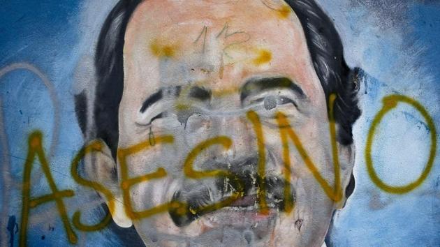 The Spanish word for “Murderer” covers a mural of President Daniel Ortega. Ortega and his wife returned to power in 2007, and to many Nicaraguans it seemed their election campaign never stopped, even growing in size and intensity as they planted billboard portraits and other ostentatious works across the country. (Esteban Felix / AP)