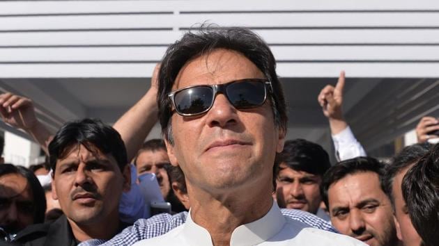 Pakistan opposition leader and head of the Pakistan Tehreek-e-Insaf Imran Khan leaves Parliament after attending a session in Islamabad on May 23, 2018(AFP)