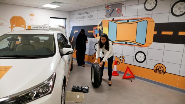 Maria al-Faraj practices how to adjust a tire during a lesson at the Driving Center. About 200 women are taking advantage of a company offer to teach female employees and their families at its driving academy in Dhahran to support the social revolution sweeping the kingdom. (Ahmed Jadallah / REUTERS) 
