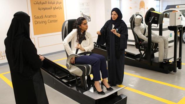 A driving instructor (R) explains seat belts to trainees Amira Abdulgader and Maria al-Faraj (C). Abdulgader wants to be sitting at the wheel, in control on June 24. “Sitting behind the wheel (means) that you are the one controlling the trip,” said the architect, dressed in a black veil, who has just finished learning to drive. (Ahmed Jadallah / REUTERS) 