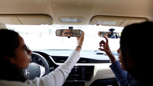Maria al-Faraj (L) adjusts a mirror during a driving lesson with instructor Ahlam al-Somali. In Amira Abdulgader’s case, the day has already been laid out in her mind. She would like to go to her mother’s house and take her for a ride. “Just me and my mother, without anyone else,” she said. (Ahmed Jadallah / REUTERS) 