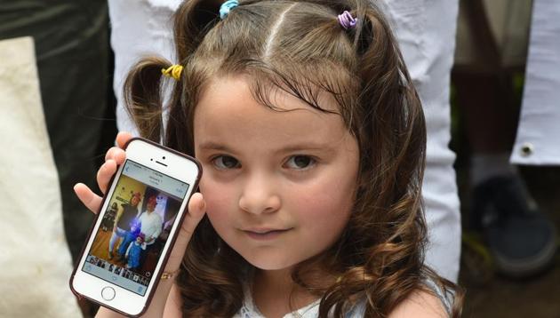 Luciana Villavicencio age 4, holds up a photo of her family on a cellphone during a press conference on June 18, 2018 regarding her father Pablo Villavicencio, an Ecuadorean, who was detained by Immigration and Customs Enforcement despite being in the process of adjusting his immigration status. His wife and two daughters are all US citizens. (AFP) Luciana Villavicencio age 4, holds up a photo of her family on a cellphone during a press conference on June 18, 2018 regarding her father Pablo Villavicencio, an Ecuadorean, who was detained by Immigration and Customs Enforcement despite being in the process of adjusting his immigration status. His wife and two daughters are all US citizens. (AFP)