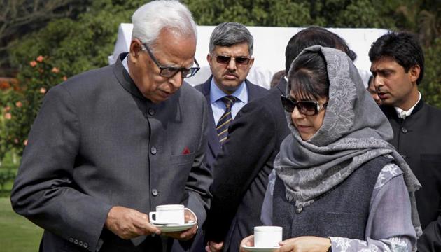 Jammu and Kashmir Governor NN Vohra with then chief minister Mehbooba Mufti in Jammu in February 2017. Mufti quit as CM on Tuesday after the BJP pulled out of the alliance government.(PTI)