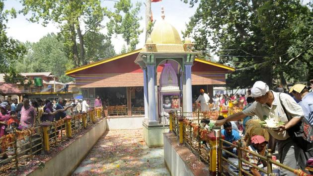 Kashmiri Hindus pour milk into a sacred spring as they pray ahead of ‘jyeshta ashtami’ at Kheer Bhawani Temple in Tullamulla Ganderbal, 28km northeast of Srinagar. (Waseem Andrabi/HT) Kashmiri Hindus pour milk into a sacred spring as they pray ahead of ‘jyeshta ashtami’ at Kheer Bhawani Temple in Tullamulla Ganderbal, 28km northeast of Srinagar. (Waseem Andrabi/HT)