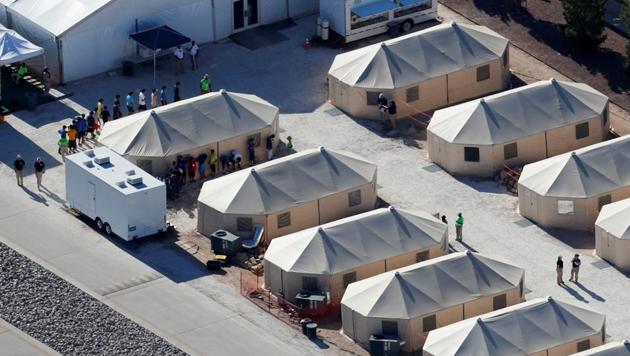 Immigrant children now housed in a tent encampment under the new "zero tolerance" policy by the Trump administration are shown walking in single file at the facility near the Mexican border in Tornillo, Texas on June 19. (REUTERS) Immigrant children now housed in a tent encampment under the new "zero tolerance" policy by the Trump administration are shown walking in single file at the facility near the Mexican border in Tornillo, Texas on June 19. (REUTERS)