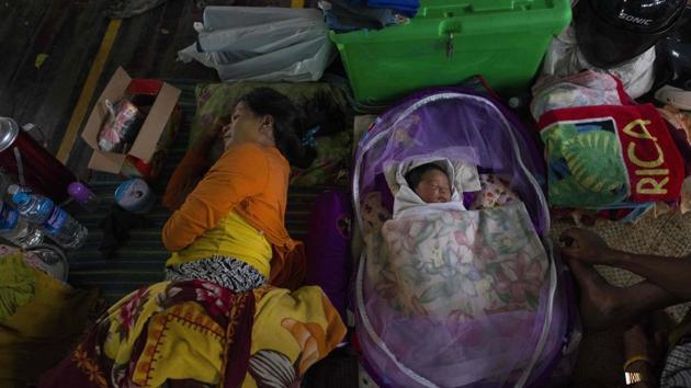 A woman with her baby displaced by the floods rest in a stadium in the township of Mawlamyine. Myanmar is one of several countries in the region to face severe yearly flooding. In 2015 it topped a global list compiled by climate scientists of nations hardest hit by extreme weather. (Ye Aung Thu / AFP)