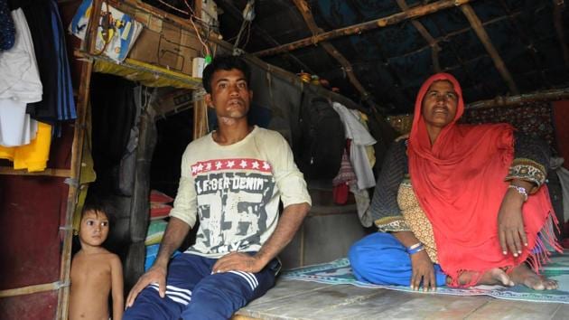 Nur Begum, 50, has been living at Chandeni camp 2 with her two sons, a daughter-in-law and grandchildren for the past four years. Her shanty is made up of cardboard supported by bamboo sticks and covered with black tarpaulin. Nur’s husband and one-year-old infant were killed in the 2012 violence in Buthidaung. Her son Dilbar Hussain (L), also sustained burns when a portion of the ceiling fell on him. (Parveen Kumar / HT Photo) 