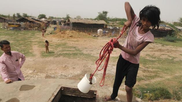 A girl fetches water from a well at Nangli camp 2 which houses 90 families of 330 refugees. Drinking water comes from a tanker. For bathing and washing, they make do from the well. Earlier, a teacher from a non-profit organisation would come to teach the children. That hasn’t been happening for the past one year. (Parveen Kumar / HT Photo) A girl fetches water from a well at Nangli camp 2 which houses 90 families of 330 refugees. Drinking water comes from a tanker. For bathing and washing, they make do from the well. Earlier, a teacher from a non-profit organisation would come to teach the children. That hasn’t been happening for the past one year. (Parveen Kumar / HT Photo)
