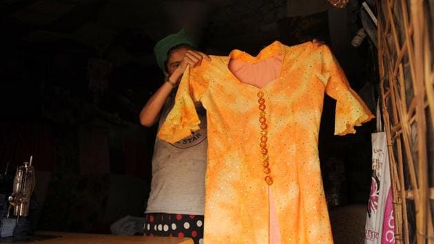 Asma, 30, shows a dress she stitched at Jogipur Ward-7 camp. “Back in Burma, my husband used to operate a boat. We had two boats and lived in a pucca house,” she said of her time in Myanmar. Children in the camp used to go to the nearby Chaudhary Mohd. Yasin Khan Meo Senior secondary school till three months ago but had to drop out after the school turned private. (Parveen Kumar / HT Photo) Asma, 30, shows a dress she stitched at Jogipur Ward-7 camp. “Back in Burma, my husband used to operate a boat. We had two boats and lived in a pucca house,” she said of her time in Myanmar. Children in the camp used to go to the nearby Chaudhary Mohd. Yasin Khan Meo Senior secondary school till three months ago but had to drop out after the school turned private. (Parveen Kumar / HT Photo)