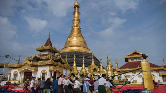 Workers save a Buddha statue after a landslide damaged the hilltop Kyeik Than Lan pagoda in Mawlamyine, Mon state following heavy rains. Flooding in southern Myanmar caused a landslide at the over 1,100-year-old pagoda, submerged homes and displaced residents, according to state media, as the monsoon season picks up strength. (Ye Aung Thu / AFP)