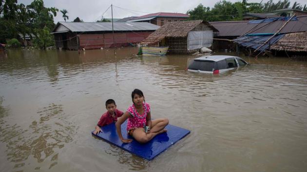 Residents use an improvised raft to move around in the flooded township of Mawlamyine. Several parts of Myanmar’s southern Mon state are facing flash floods due to heavy rains since the weekend with no relief in sight, according to a report in the state-run Global New Light of Myanmar on Monday. (Ye Aung Thu / AFP)