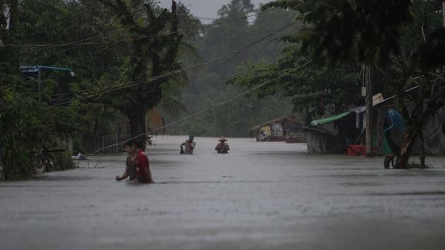 About 150 residents further south of Mawlamyine were evacuated to a government school after dozens of homes and bridges were submerged, while a monastery was destroyed across the river from the city, the New Light reported. (Ye Aung Thu / AFP)